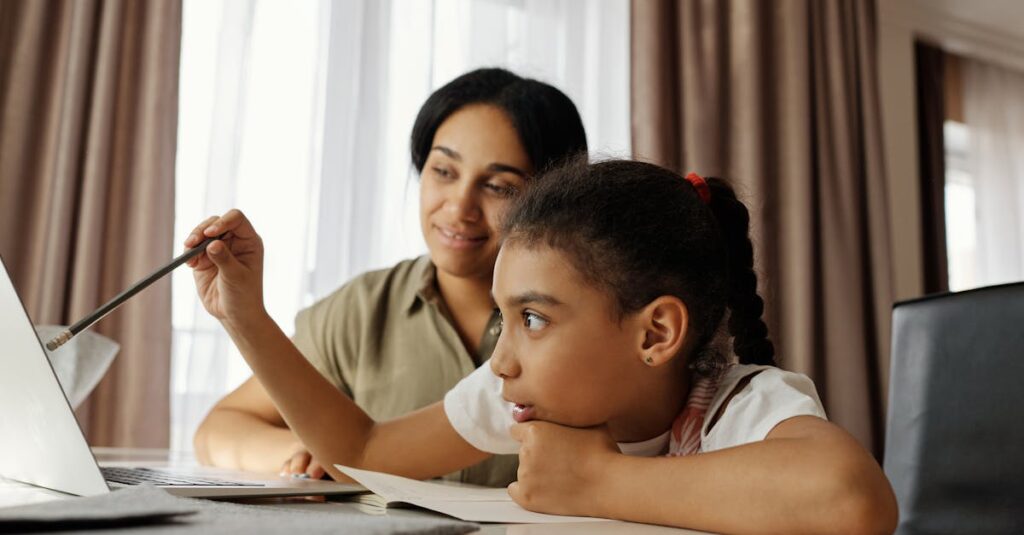 Mother and daughter engaged in online learning at home, using a laptop.